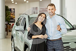 Beautiful couple buy new car in dealership