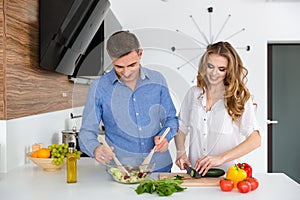 Beautiful couple cooking healthy food together