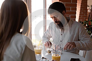 Beautiful couple eating their breakfast at home, family have a good time together