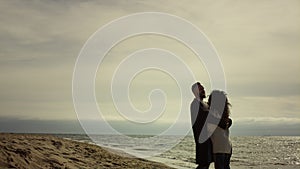 Beautiful couple embracing beach at nature. Boyfriend girlfriend hugging by sea.