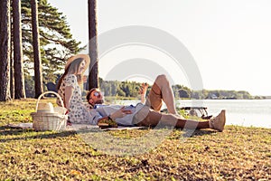 Beautiful couple enjoying picnic time on the sunset