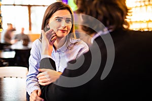 Beautiful couple having coffee on a date. Two people in cafe enjoying the time spending with each other