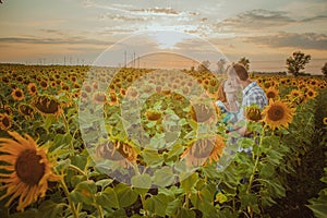 Beautiful couple having fun in sunflowers fields
