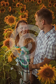 Beautiful couple having fun in sunflowers fields