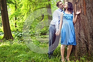 Beautiful couple having romantic moment in forest