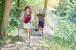 Beautiful couple of hiker wearing backpack smiling happy