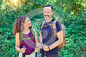 Beautiful couple of hiker wearing backpack smiling happy