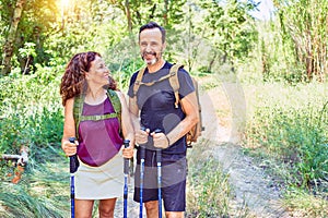 Beautiful couple of hiker wearing backpack smiling happy