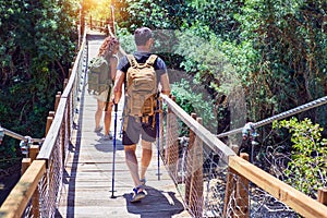 Beautiful couple of hiker wearing explorer clothes and  backpack