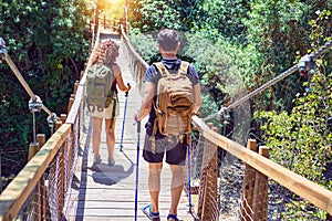 Beautiful couple of hiker wearing explorer clothes and  backpack