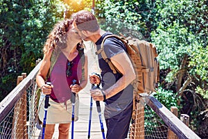 Beautiful couple of hiker wearing explorer clothes and  backpack