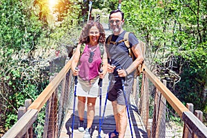 Beautiful couple of hiker wearing explorer clothes and  backpack smiling happy