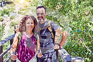 Beautiful couple of hiker wearing explorer clothes and  backpack smiling happy