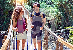 Beautiful couple of hiker wearing explorer clothes and  backpack smiling happy