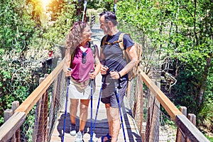 Beautiful couple of hiker wearing explorer clothes and  backpack smiling happy