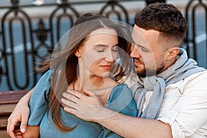 Beautiful couple are hugging with love and tenderness on city street