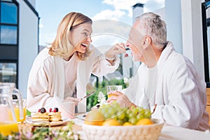 Beautiful couple leading healthy lifestyle having fruits and juice for breakfast