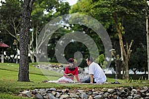 Beautiful couple learning together in the park. Education, love and tenderness, dating, romanc