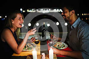 Beautiful couple in love having romantic dinner at night