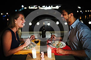 Beautiful couple in love having romantic dinner at night