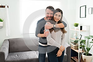 Beautiful couple in love hugging after moving in together