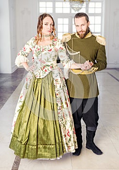 Beautiful couple man and woman in historical costumes