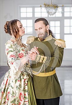 Beautiful couple man and woman in historical costumes
