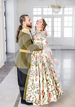 Beautiful couple man and woman in historical costumes