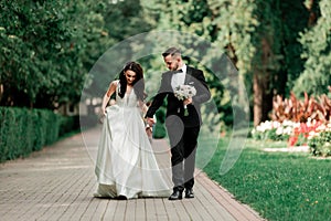 Beautiful couple newlyweds on a walk in the city Park