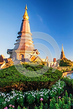 Beautiful couple pagodas and flowers garden at sunset, scenery landscape of tropical garden on the top of Doi Inthanon mountain.