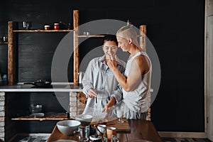 Beautiful couple preparing a meal together while spending free time at home