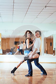 Beautiful couple of professional artists dancing passionate danc