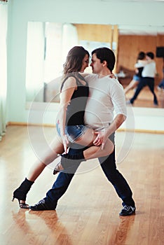 Beautiful couple of professional artists dancing passionate danc