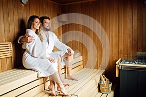 Beautiful couple relaxing in sauna