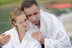 Beautiful couple resting with bathrobe at thalasso resort