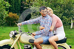 Beautiful couple on retro motorbike