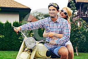 Beautiful couple on retro motorbike