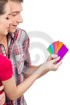 Beautiful couple selecting color and smiling.