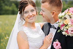 Beautiful couple on their wedding day. Portrait of groom and bride. Green background