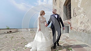 Beautiful couple walking in the castle. Handsome man and tenderness woman