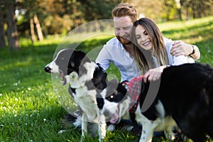 Beautiful couple walking dogs and bonding in nature