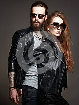 Beautiful couple wearing trendy glasses together. Tattooed couple