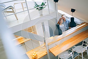 Beautiful couple in well designed kitchen