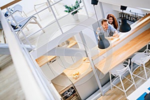 Beautiful couple in well designed kitchen