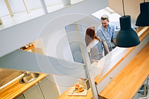 Beautiful couple in well designed kitchen