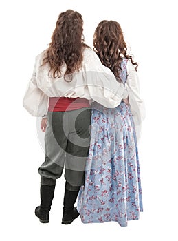 Beautiful couple woman and man in medieval clothes. Back pose