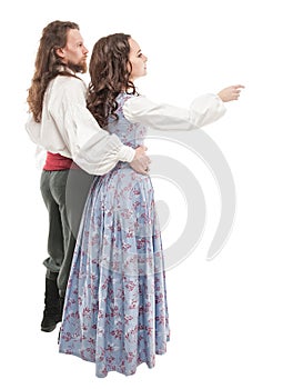 Beautiful couple woman and man in medieval clothes. Back pose