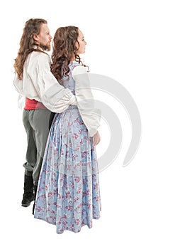 Beautiful couple woman and man in medieval clothes. Turn pose