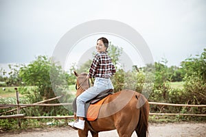 beautiful cowboy girl riding a horse while going