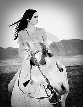 Beautiful Cowgirl Riding White Dapple Horse